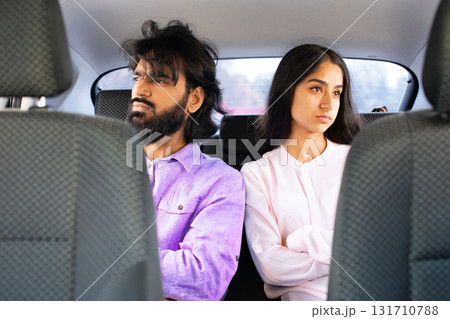 Indian couple sitting in silence in car, looking away from each other 131710788