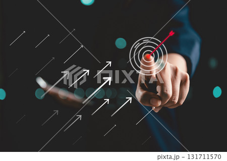 Businessperson touching virtual dartboard with arrow, Business achievement objective target concept. strategy and support of technology, business aims its arrow toward target market, growth, success. Businessperson touching virtual dartboard with arrow, Business achievement objective target concept. strategy and support of technology, business aims its arrow toward target market, growth, success. 131711570