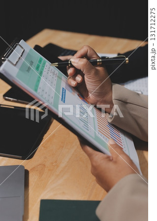 Accounting company provide finance and taxation planning for profitable cash flow, Auditor and accountant team working in office, analyze financial data and accounting record with calculator.Insight 131712275