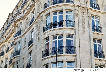 Haussmannian building facade showing ornate balconies and traditional European residential apartment architecture in a city. Antwerp, Belgium Haussmannian building facade showing ornate balconies and traditional European residential apartment architecture in a city. Antwerp, Belgium 131712402