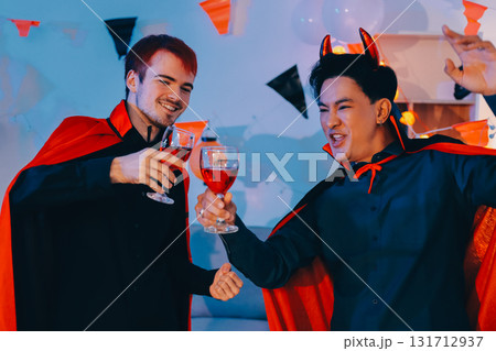 Joyful office Halloween party with coworkers in costumes, celebrating with drinks and laughter, fostering teamwork and festive spirit 131712937