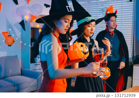 Joyful office Halloween party with coworkers in costumes, celebrating with drinks and laughter, fostering teamwork and festive spirit 131712939