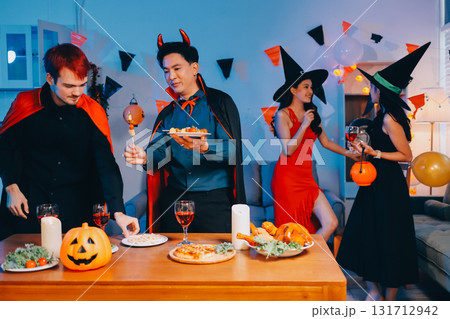 Joyful office Halloween party with coworkers in costumes, celebrating with drinks and laughter, fostering teamwork and festive spirit 131712942