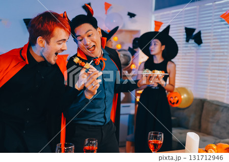 Joyful office Halloween party with coworkers in costumes, celebrating with drinks and laughter, fostering teamwork and festive spirit Joyful office Halloween party with coworkers in costumes, celebrating with drinks and laughter, fostering teamwork and festive spirit 131712946