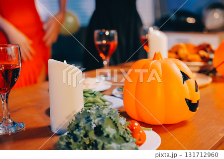 Joyful office Halloween party with coworkers in costumes, celebrating with drinks and laughter, fostering teamwork and festive spirit 131712960
