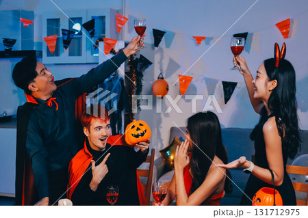 Joyful office Halloween party with coworkers in costumes, celebrating with drinks and laughter, fostering teamwork and festive spirit 131712975