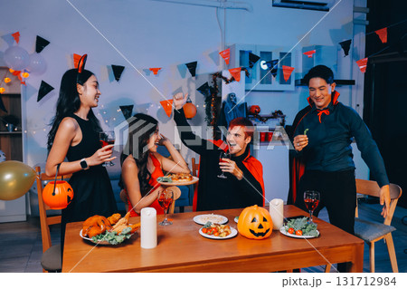 Joyful office Halloween party with coworkers in costumes, celebrating with drinks and laughter, fostering teamwork and festive spirit Joyful office Halloween party with coworkers in costumes, celebrating with drinks and laughter, fostering teamwork and festive spirit 131712984