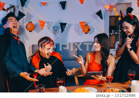 Joyful office Halloween party with coworkers in costumes, celebrating with drinks and laughter, fostering teamwork and festive spirit 131712986