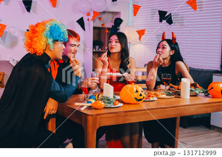 Joyful office Halloween party with coworkers in costumes, celebrating with drinks and laughter, fostering teamwork and festive spirit Joyful office Halloween party with coworkers in costumes, celebrating with drinks and laughter, fostering teamwork and festive spirit 131712999