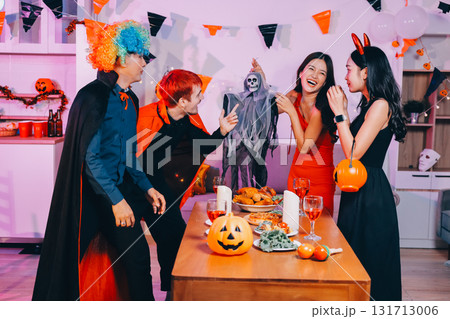 Joyful office Halloween party with coworkers in costumes, celebrating with drinks and laughter, fostering teamwork and festive spirit 131713006