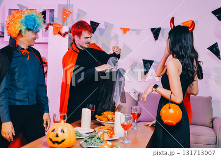 Joyful office Halloween party with coworkers in costumes, celebrating with drinks and laughter, fostering teamwork and festive spirit 131713007