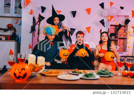 Joyful office Halloween party with coworkers in costumes, celebrating with drinks and laughter, fostering teamwork and festive spirit Joyful office Halloween party with coworkers in costumes, celebrating with drinks and laughter, fostering teamwork and festive spirit 131713015