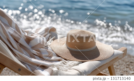 Relaxing beach setting with a straw hat and soft blanket by the shore 131713140