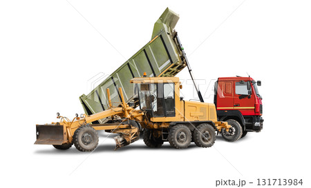 A powerful grader and a dump truck with a raised dump body against an isolated background. Road construction equipment. 131713984
