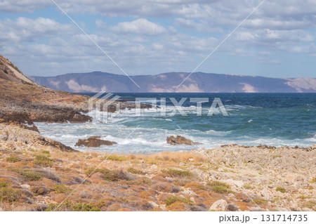 Cretan seascape in windy weather with strong surf and white foam on the sea. Cretan seascape in windy weather with strong surf and white foam on the sea. 131714735