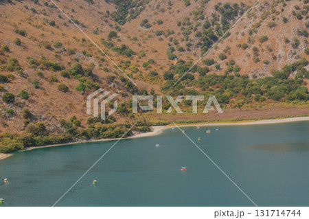 Hidden mountain lake with calm turquoise water red rocks and green trees. Hidden mountain lake with calm turquoise water red rocks and green trees. 131714744