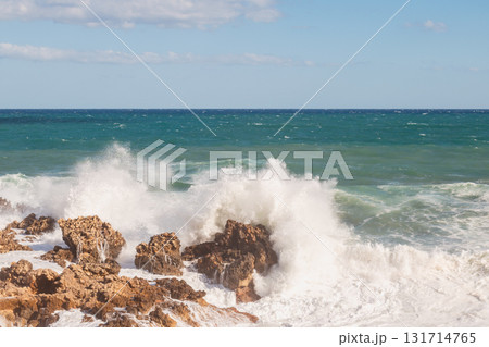 Stormy seascape with waves crashing against rocky shore and high white foam splashes. Stormy seascape with waves crashing against rocky shore and high white foam splashes. 131714765