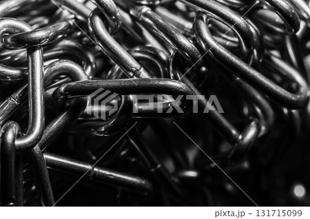 The steel chain lies on a dark background The steel chain lies on a dark background 131715099