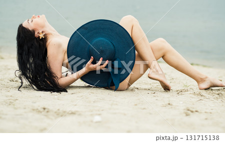 The beauty is basking in the sun on the sandy shore near a pond The beauty is basking in the sun on the sandy shore near a pond 131715138