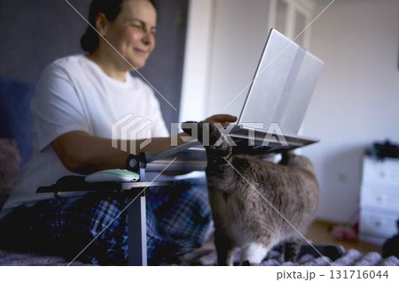 a  senior woman working from home on laptop 131716044
