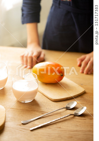 Fresh mango with yogurt drinks on wooden table Fresh mango with yogurt drinks on wooden table 131717383