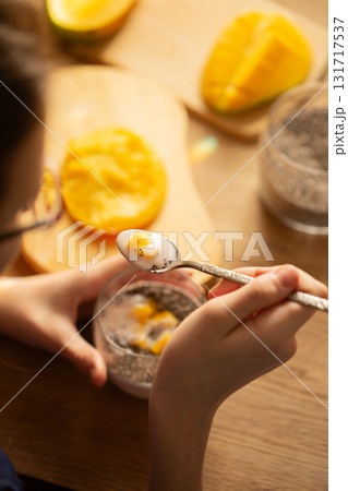 Mango chia pudding with coconut milk served in glass 131717537