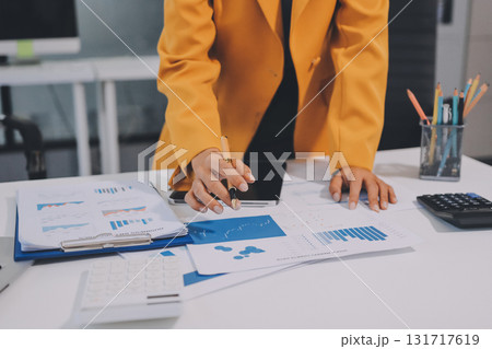 Accounting company provide finance and taxation planning for profitable cash flow, Auditor and accountant team working in office, analyze financial data and accounting record with calculator.Insight Accounting company provide finance and taxation planning for profitable cash flow, Auditor and accountant team working in office, analyze financial data and accounting record with calculator.Insight 131717619