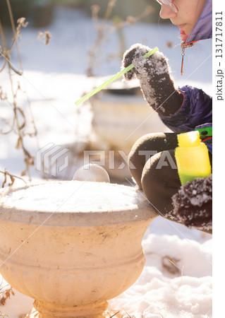 Winter science experiment with frozen soap bubble on snow 131717811