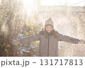 Happy boy playing in flying winter snow outdoors 131717813