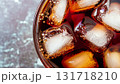 macro photo of a glass with Coca Cola and ice cubes top view 131718210