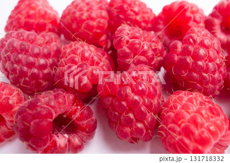 fresh raspberries arranged on clean surface their vibrant red color and natural texture. closeup. 131718332