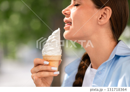 Icecream Woman Summer Taste Woman licks ice cream cone on a summer day outside to enjoy the sweet treat. Icecream Woman Summer Taste Woman licks ice cream cone on a summer day outside to enjoy the sweet treat. 131718364