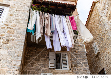 Laundry Drying on the Line Between Historic Stone Buildings in Budva Old Town 131718529