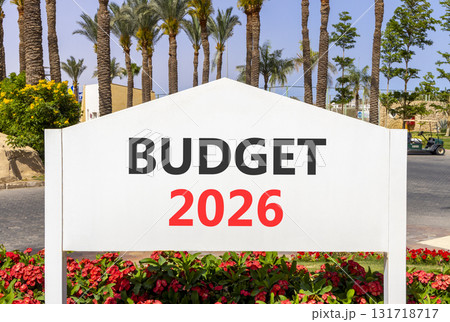 Budget 2026 symbol. Concept words Budget 2026 on beautiful white road sign. Beautiful palm trees palm-trees and blue sky background. Business and budget 2026 concept. Copy space. 131718717