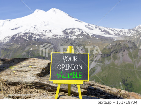 Your opinion valuable symbol. Concept words Your opinion valuable on beautiful black yellow blackboard. Beautiful mountain Elbrus background. Business your opinion valuable concept. Copy space. 131718734