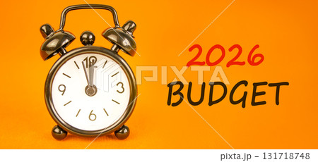 2026 Budget symbol. Concept words 2026 Budget on beautiful orange paper. Beautiful orange paper background. Beautiful black alarm clock. Business and 2026 budget concept. Copy space. 2026 Budget symbol. Concept words 2026 Budget on beautiful orange paper. Beautiful orange paper background. Beautiful black alarm clock. Business and 2026 budget concept. Copy space. 131718748