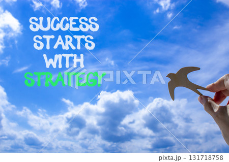 Success starts with strategy symbol. Concept words Success starts with strategy. Beautiful blue sky and clouds background. Business and success starts with strategy concept. Copy space. Success starts with strategy symbol. Concept words Success starts with strategy. Beautiful blue sky and clouds background. Business and success starts with strategy concept. Copy space. 131718758