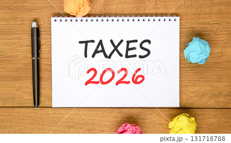 Taxes 2026 new year symbol. Concept words Taxes 2026 on beautiful white note. Beautiful wooden background. Black pen. Colored paper. Business and taxes 2026 new year concept. Copy space. Taxes 2026 new year symbol. Concept words Taxes 2026 on beautiful white note. Beautiful wooden background. Black pen. Colored paper. Business and taxes 2026 new year concept. Copy space. 131718788