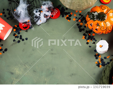 Halloween green frame background flatlay with pumpkins and party decor 131719039