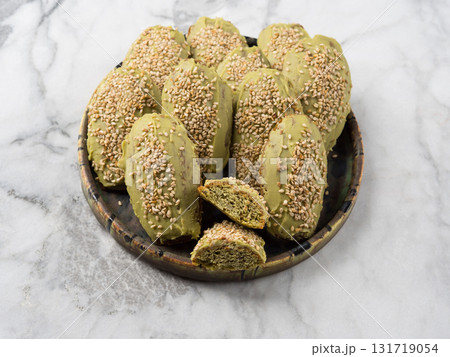 Matcha madeleine cookies with white chocolate frosting on marble background Matcha madeleine cookies with white chocolate frosting on marble background 131719054
