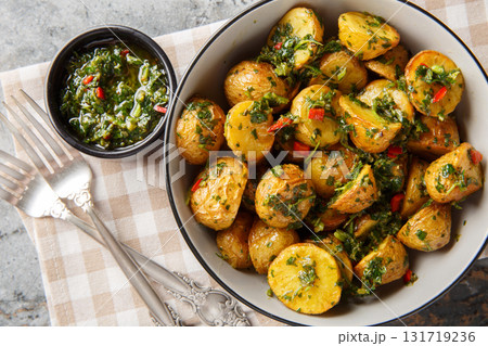 roasted chimichurri potatoes are a great side dish all year round closeup on the plat. Horizontal top view roasted chimichurri potatoes are a great side dish all year round closeup on the plat. Horizontal top view 131719236