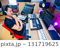 asian male music producer, sound engineer, composer, musician. artist enjoy listening his song in home studio. 131719625
