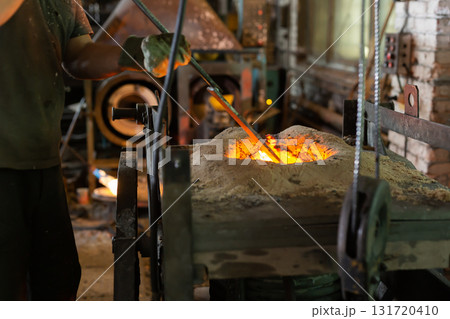 Ferrous metal billet is melted in an induction furnace closeup Ferrous metal billet is melted in an induction furnace closeup 131720410