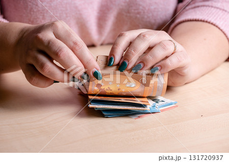 business, finance, saving, banking and people concept - close-up of woman hands counting euro money 131720937