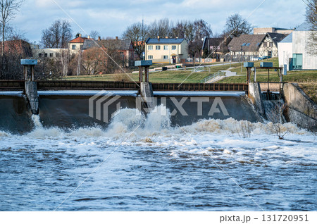 Spring flood water flows over the locks on the Berze river in Dobele, Latvia 131720951