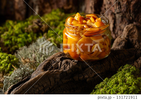 Homemade pickled honey mushrooms in a glass jar. 131721911