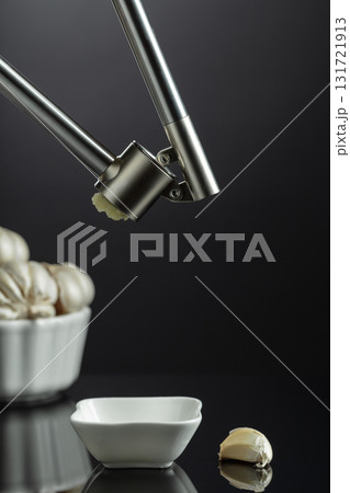 Garlic bulbs and garlic press. 131721913