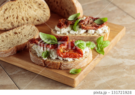 Ciabatta with sun dried tomatoes in olive oil, ricotta, and basil. Ciabatta with sun dried tomatoes in olive oil, ricotta, and basil. 131721928