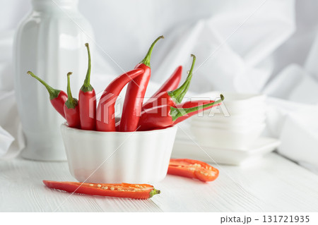 Fresh red chili peppers with on a white wooden table. 131721935