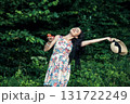 A cute woman with two red apples in the forest 131722249